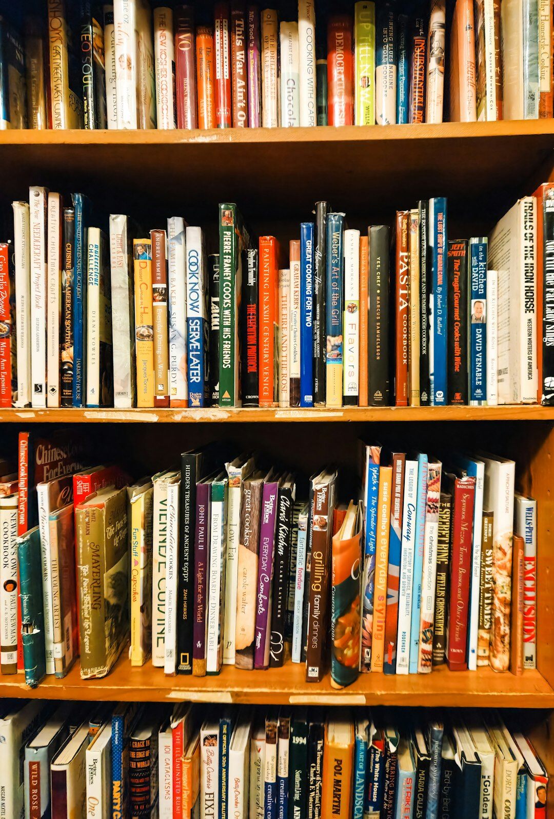 Tall old library bookshelves filled with hardcover novels