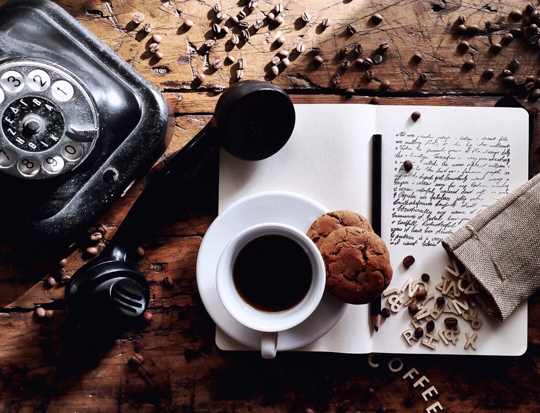 Vintage typewriter with typed manuscript pages and a cup of coffee on a wooden table