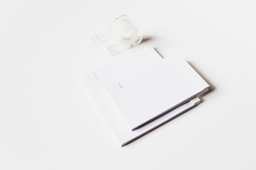 Desk scene with an open notebook, fountain pen and magnifying glass