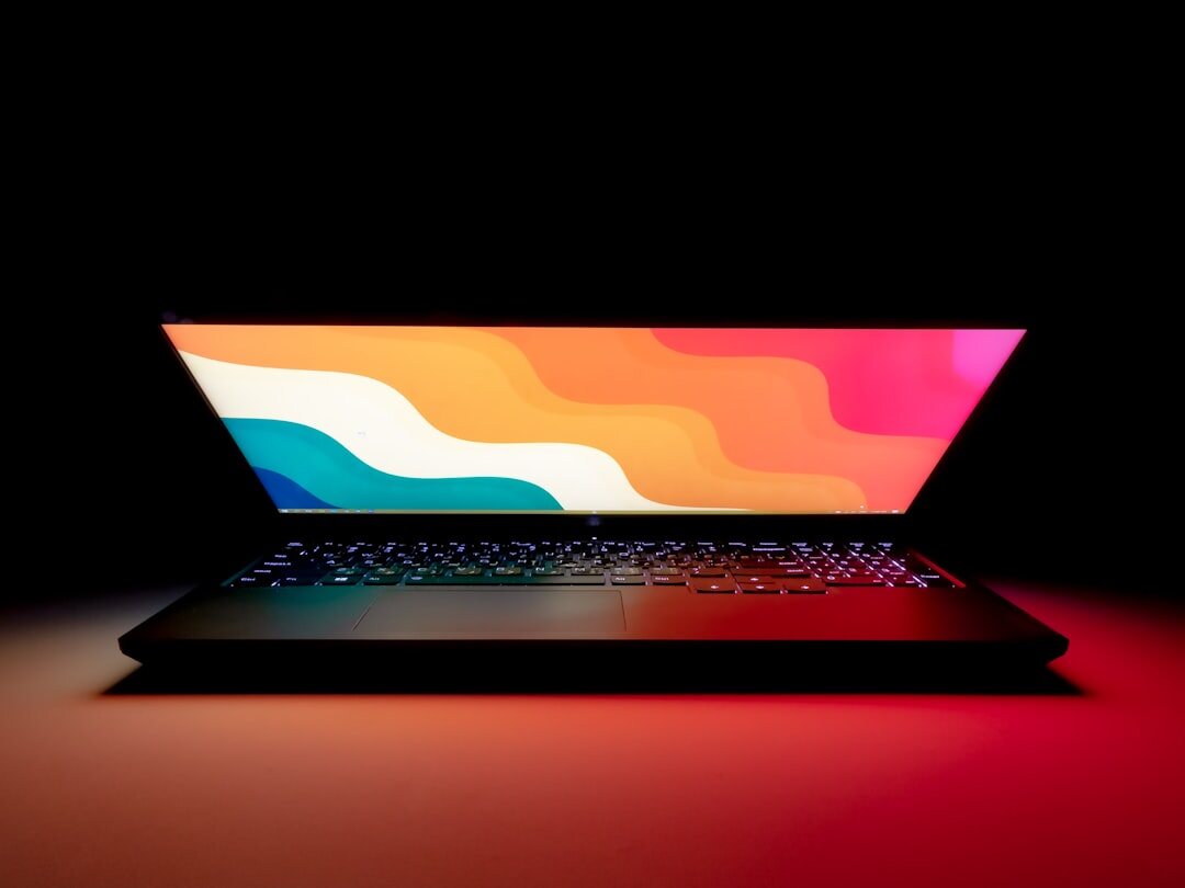 writer typing on laptop in dark room