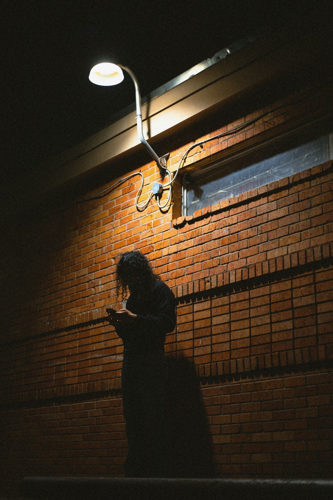 person reading book by lamp